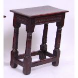 *An 18th century oak joint stool, having a chip carved frieze, on turned square cut supports, w.