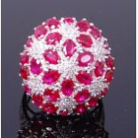 An 18ct white gold, ruby and diamond cocktail ring, the large convex setting diameter 26mm,