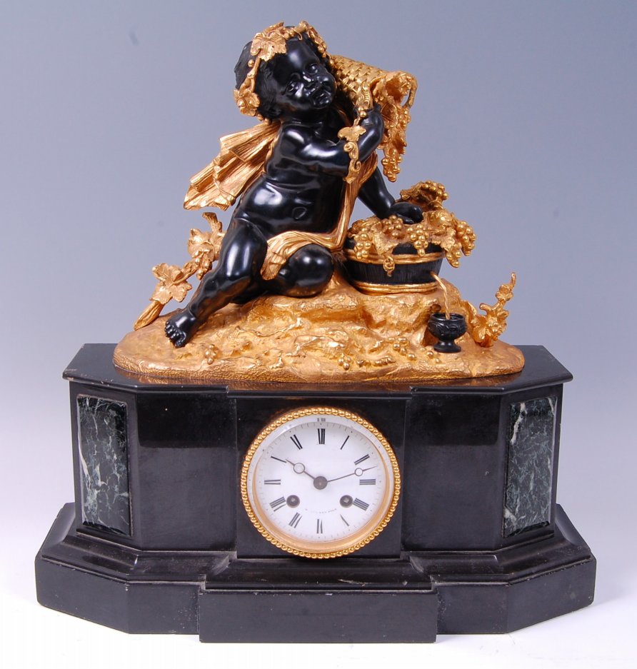 A late 19th century French gilt and patinated bronze black slate mantel clock,
