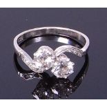 An Art Deco platinum diamond crossover ring, the claw set old cut diamonds each weighing approx 0.