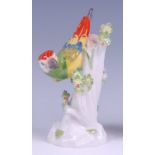A Meissen porcelain model of a parrot upon a treestump, naturalistically posed,