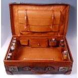 A circa 1900 brown leather travel case,