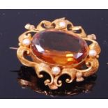 A circa 1900 yellow metal, topaz and seed pearl set brooch,