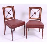 *A pair of late Georgian mahogany dining chairs, of unusual outline,