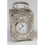 A late Victorian silver minuet carriage clock, having swing handle and floral embossed decoration,