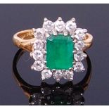 An 18ct gold, emerald and diamond ring, the centre claw set octagon cut emerald weighing approx 2ct,