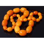 A single string of butterscotch amber barrel beads, being graduated and knotted,