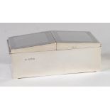 An Art Deco silver table cigarette box, having twin engraved hinged covers,