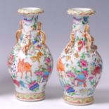 A pair of late 19th century Chinese Canton enamel decorated vases,
