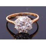 An 18ct gold diamond cluster ring, the centre claw set old cut diamond weighing approx 0.