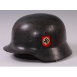 A German SS M35 steel helmet with ducals, leather lining and chin strap,