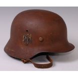 A German M35 steel helmet with remains of SS decal, leather liner and chin strap.