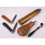 A 19th century shot measure, together with a copper powder flask, inert shell and two pocket knives.