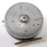 A Hardy Wallis 4" alloy centre pin trotting reel, with drop latch release and ribbed brass foot.