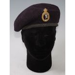 A Royal Signals blue beret with badge, dated 1945 to the interior.