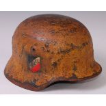A German Wehrmacht M35 steel helmet with decals, leather liner and chin strap.