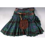 A post WW II tartan kilt with leather straps and sporran.