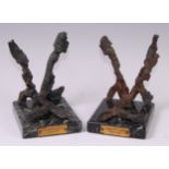 A pair of marble mounted bookends made from shrapnel of Coventry's Blitz 1940-41. h.15cm.