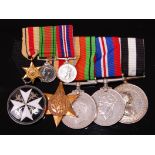 A group of five medals to include The Order of St John, Africa Star, Defence,