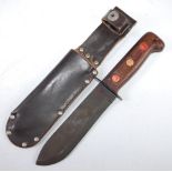An unmarked Bowie style knife, having an 18cm blade and two piece wooden grip, in a leather sheath,