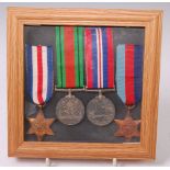 A group of four WW II medals to include 1939-45 Star, France & Germany Star, War and Defence,