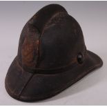 An early 20th century Leyton? Fire Brigade leather helmet, the coat of arms worn,