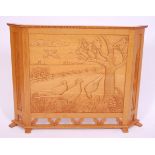 A light oak fire screen, the front panel carved with pheasants amongst a landscape, w.110cm.