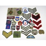 A quantity of military cloth insignia