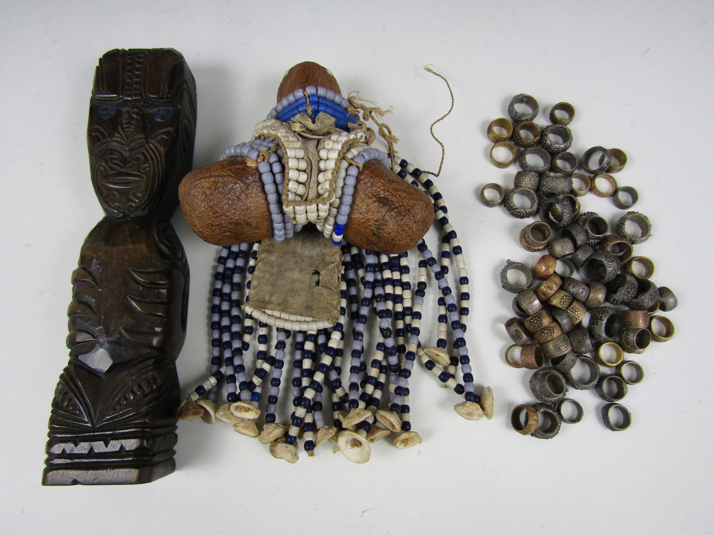 A Maori carved and inlaid wooded Tiki figure together with various other items of ethnic bead-work