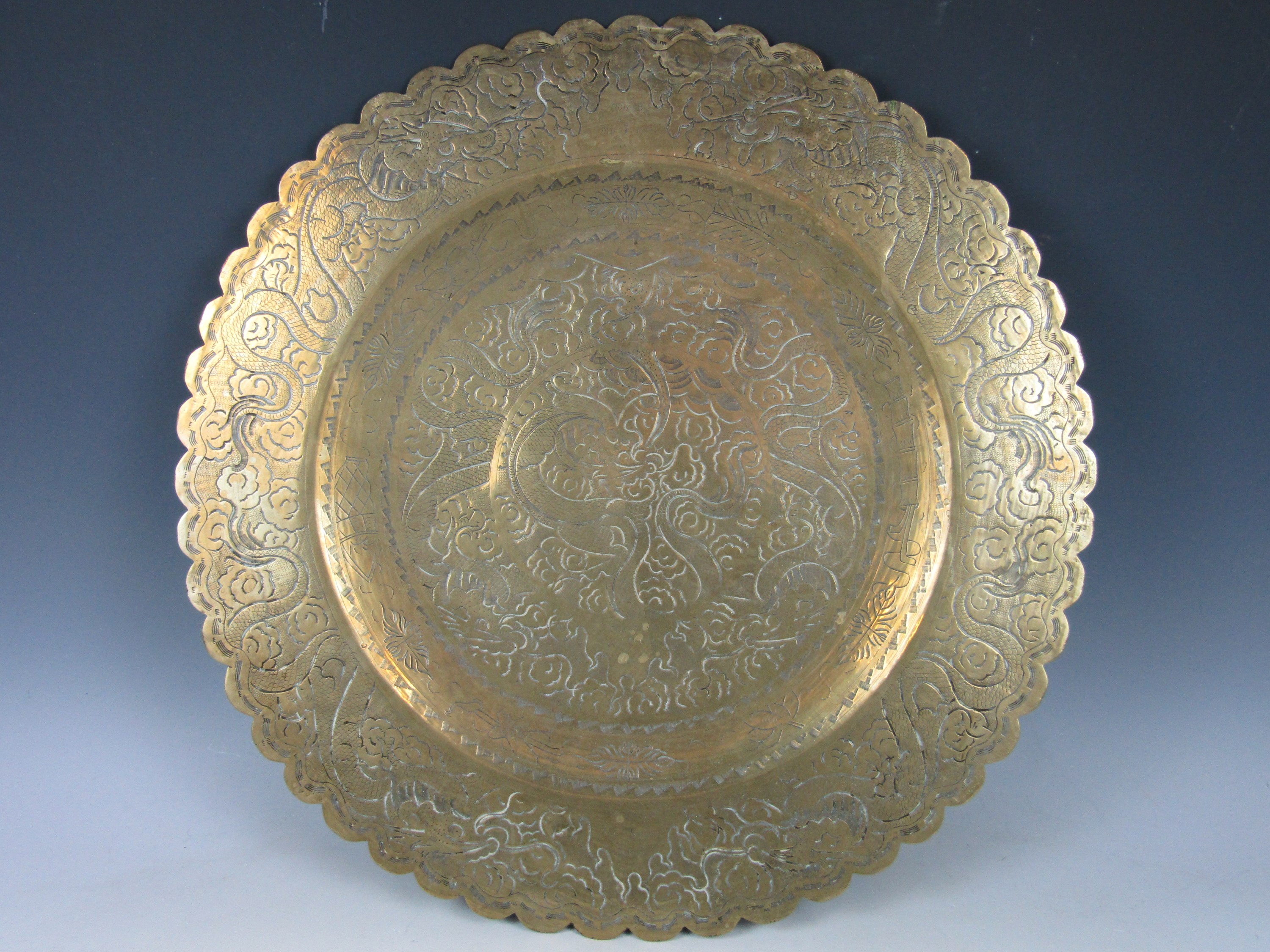 A Chinese brass circular tray