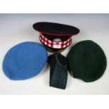 Three items of late 20th Century British military headdress comprising a UN and Royal Marines