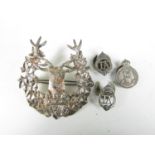 A Gordon Highlanders badge and three Army reserve and related lapel badges