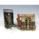 A vintage Kodak folding roll film camera and Edwardian field glasses