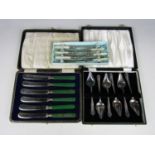 Electroplate grapefruit spoons together with other cased electroplate cutlery