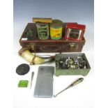 A vintage hide case with collectibles including a brass fishing reel, a money box and a coronation