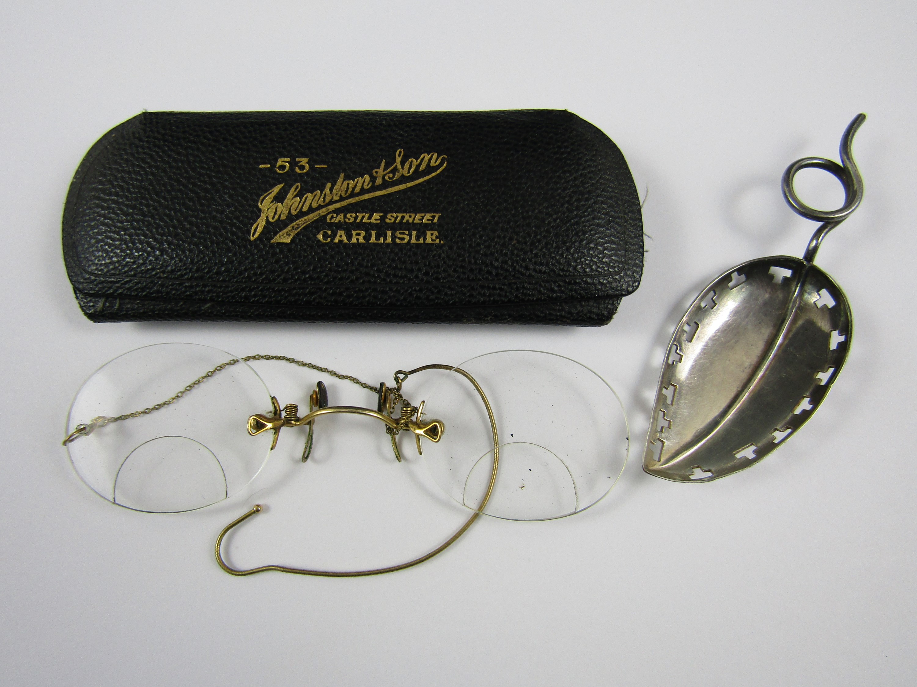 Pince nez glasses together with a caddy spoon