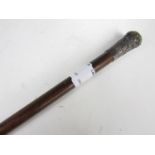 A swagger stick with white metal pommel