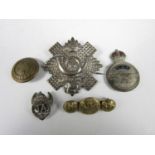 Sundry items of military insignia including an early RAF lapel badge brooch