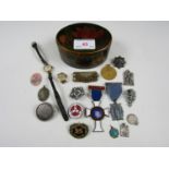 A covered trinket box together with a box containing a watch, a medallion and various badges