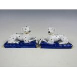 A pair of quality reproduction porcelain Dalmatians on cushions