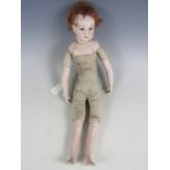 A reproduction Victorian bisque head and shouldered doll, with fixed blue glass eyes, painted