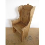 A reproduction pine lambing chair