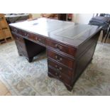 A contemporary mahogany pedestal desk