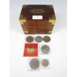 A brass-mounted money box containing a small quantity of coins