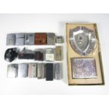 A quantity of vintage cigarette lighters and related material including a KKW camera lighter