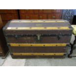 A late 19th / early dome-top trunk with affixed Grenadier Guards brass badge