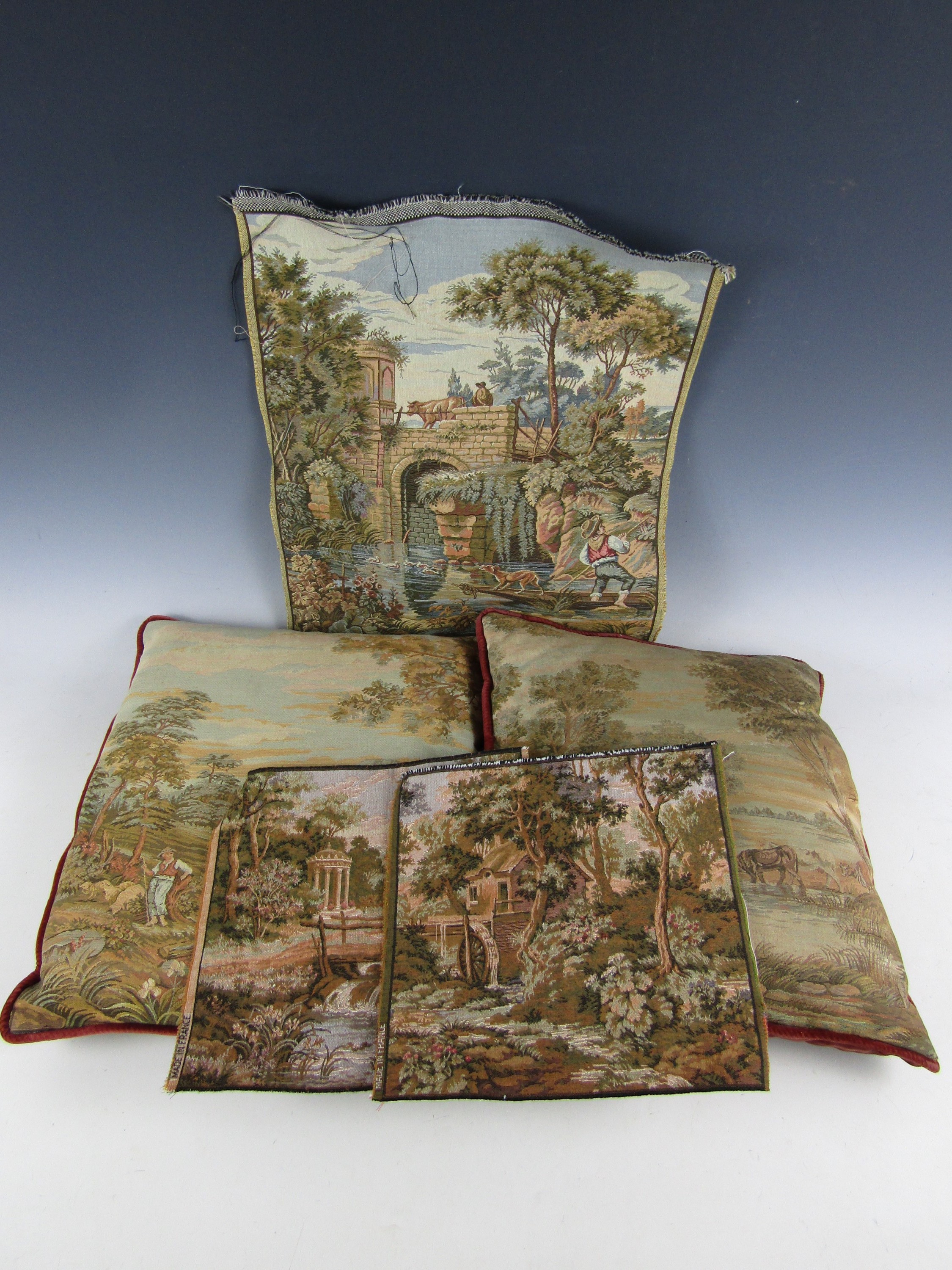 A pair of vintage tapestry scatter cushions, each depicting a different rural idyll, backed in