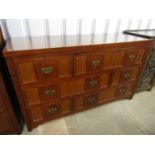 A large contemporary mahogany chest of drawers