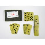 A set of early 20th Century miniature ivorine dominoes in leather wallet