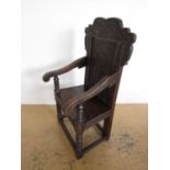 An old reproduction Wainscote joined-oak armchair